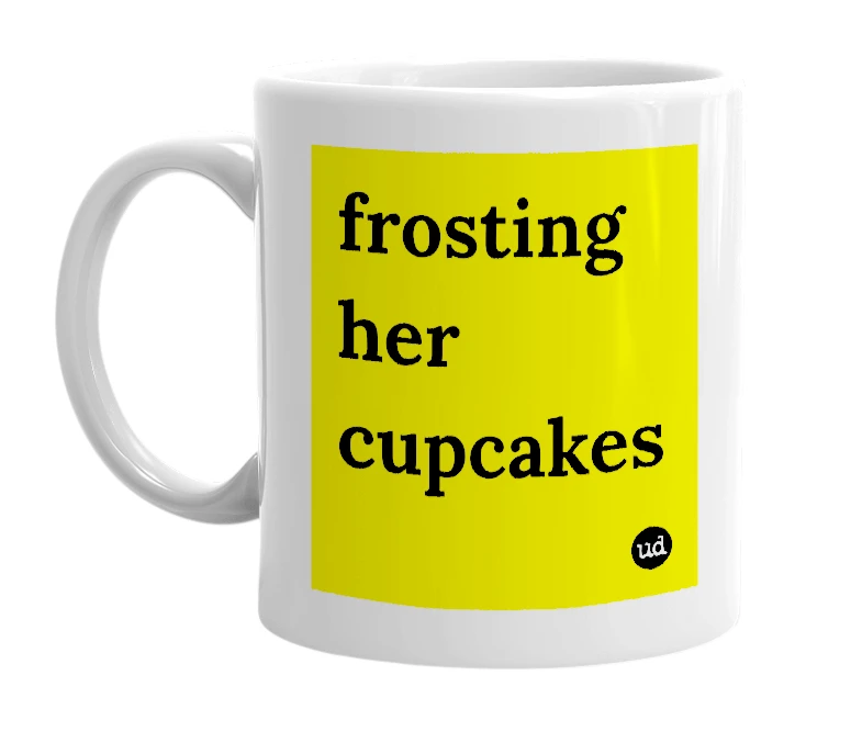 White mug with 'frosting her cupcakes' in bold black letters