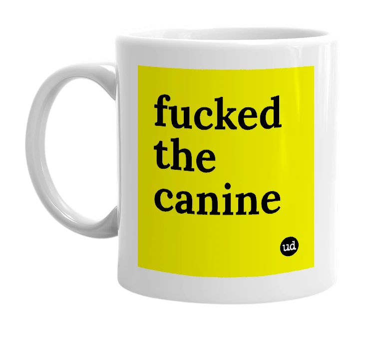 White mug with 'fucked the canine' in bold black letters