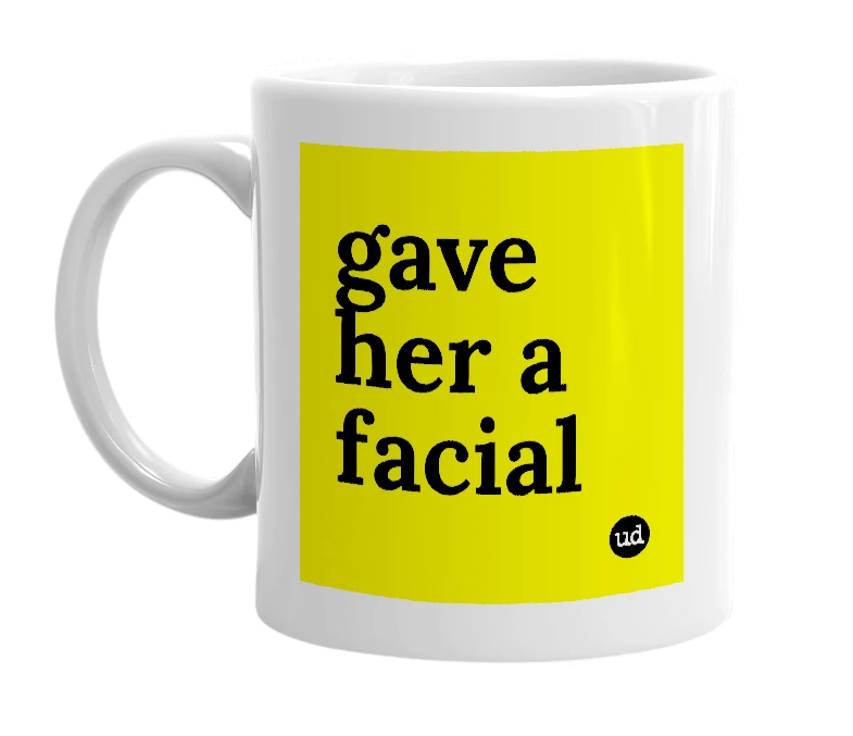 White mug with 'gave her a facial' in bold black letters
