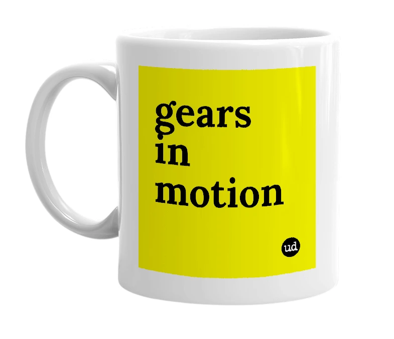 White mug with 'gears in motion' in bold black letters