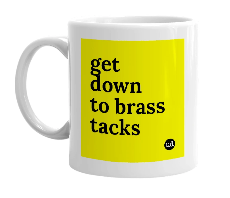 White mug with 'get down to brass tacks' in bold black letters