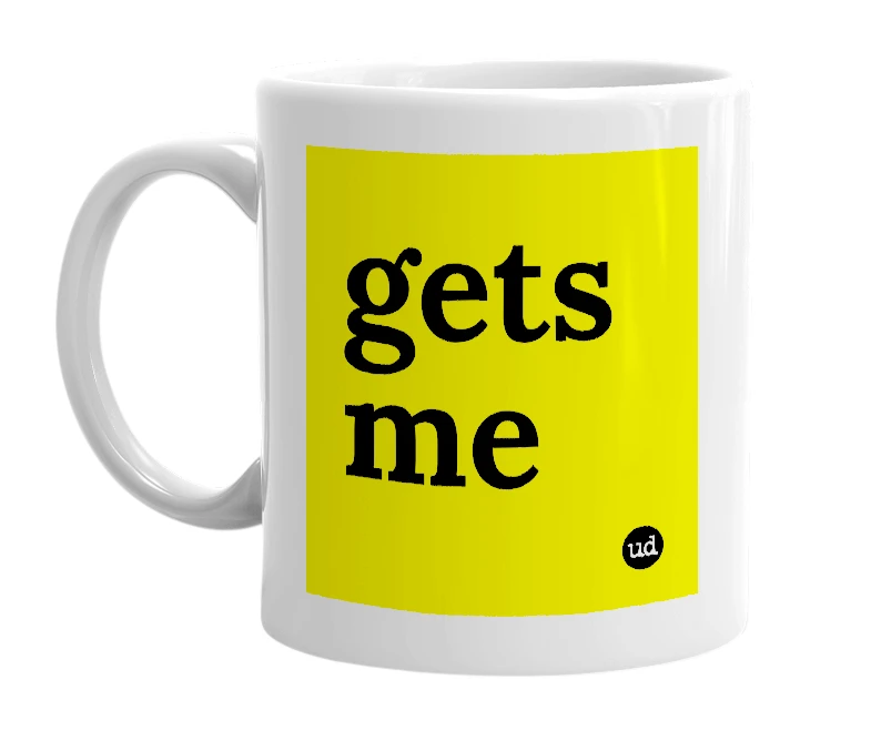 White mug with 'gets me' in bold black letters