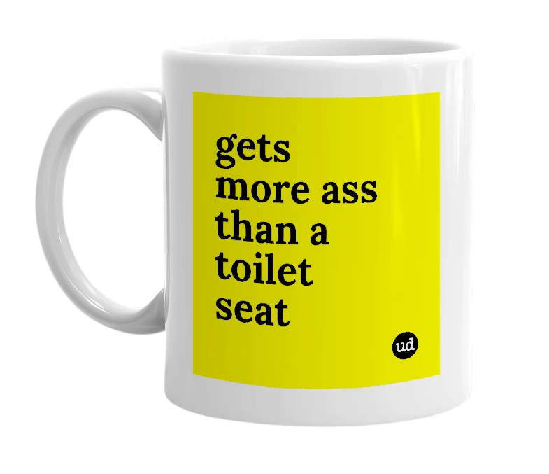 White mug with 'gets more ass than a toilet seat' in bold black letters