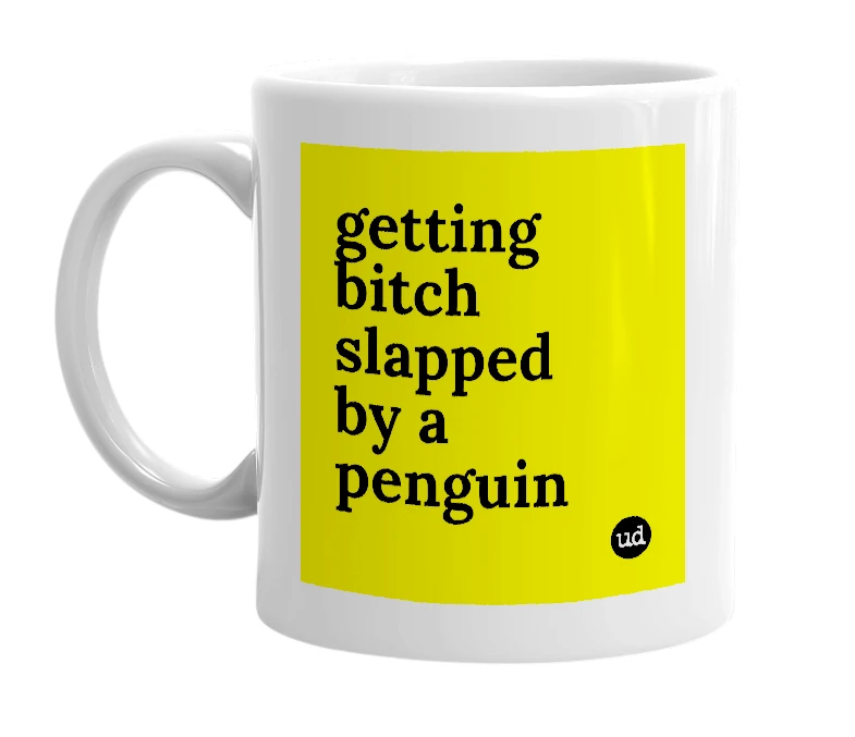 White mug with 'getting bitch slapped by a penguin' in bold black letters