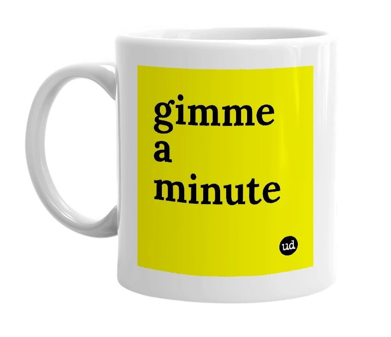 White mug with 'gimme a minute' in bold black letters