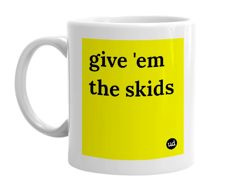 White mug with 'give 'em the skids' in bold black letters
