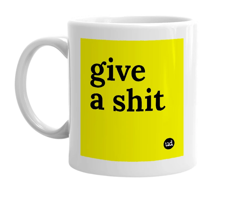 White mug with 'give a shit' in bold black letters