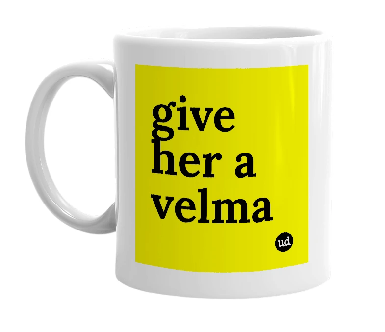 White mug with 'give her a velma' in bold black letters