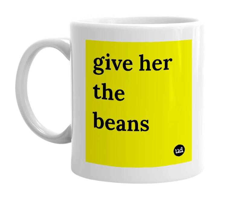 White mug with 'give her the beans' in bold black letters