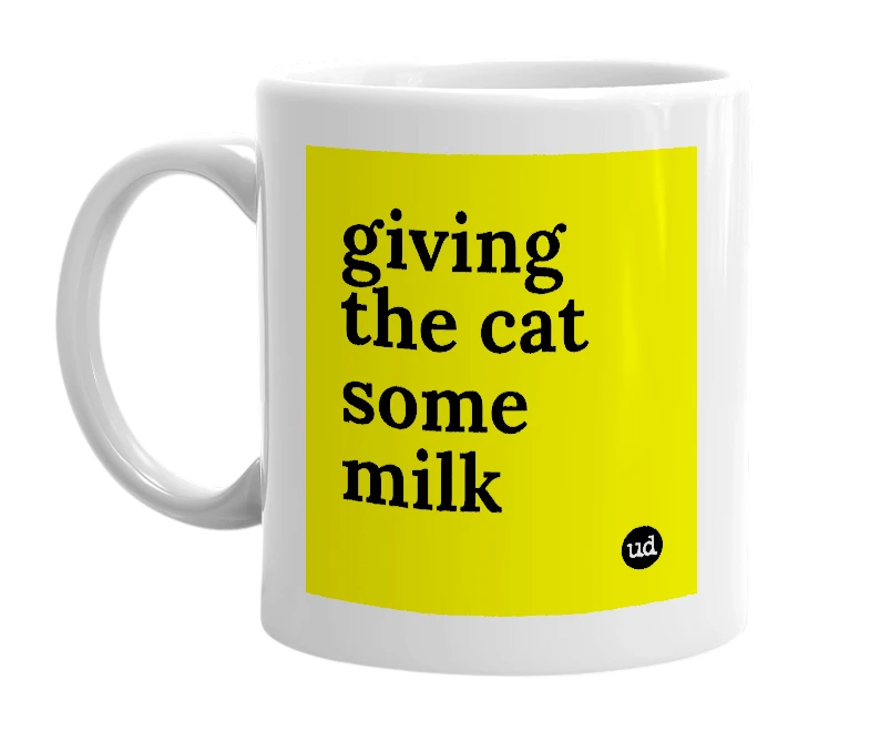 White mug with 'giving the cat some milk' in bold black letters