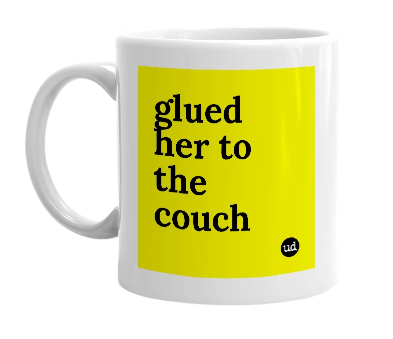 White mug with 'glued her to the couch' in bold black letters