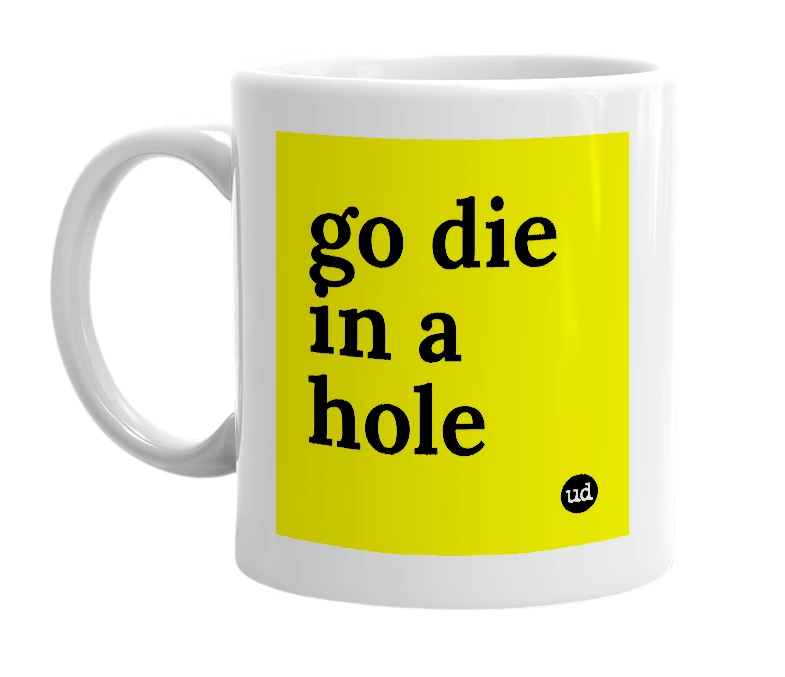 White mug with 'go die in a hole' in bold black letters