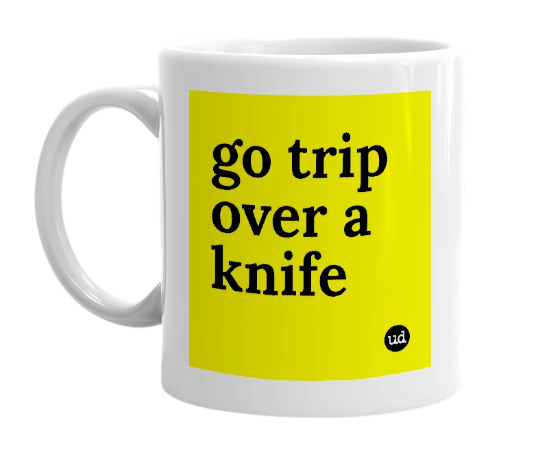 White mug with 'go trip over a knife' in bold black letters