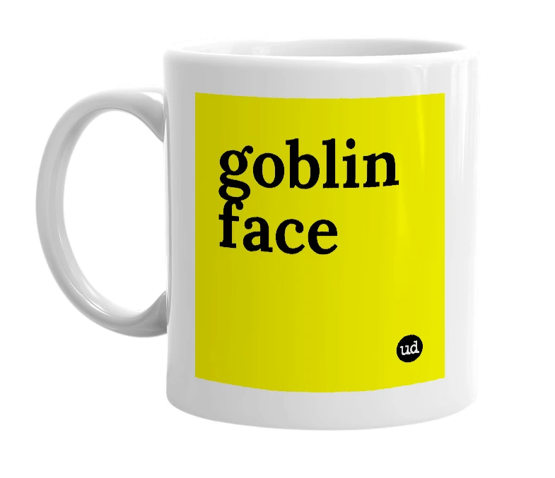 White mug with 'goblin face' in bold black letters