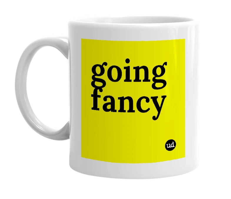 White mug with 'going fancy' in bold black letters