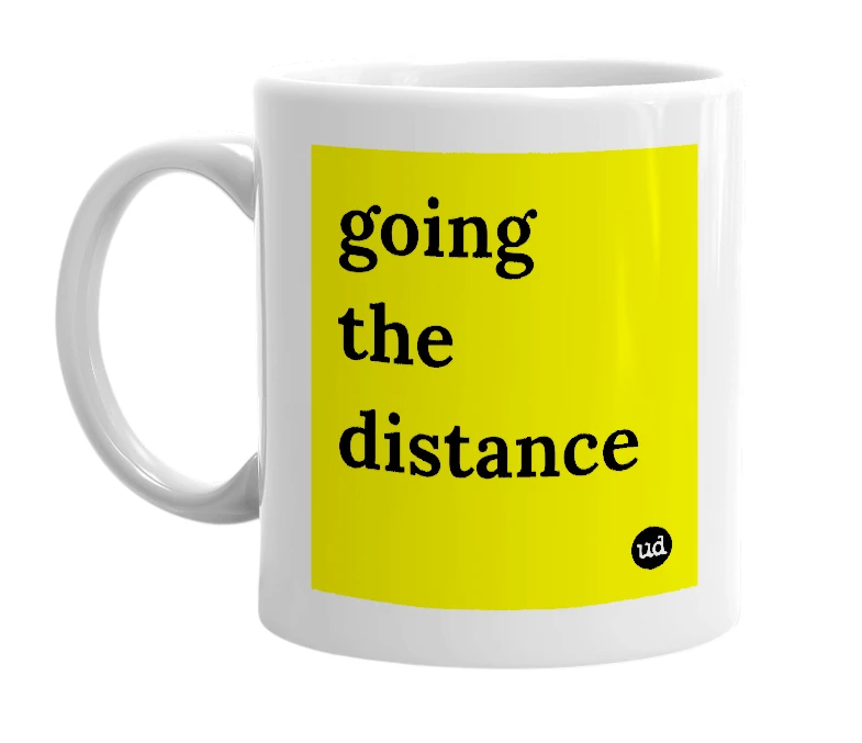 White mug with 'going the distance' in bold black letters