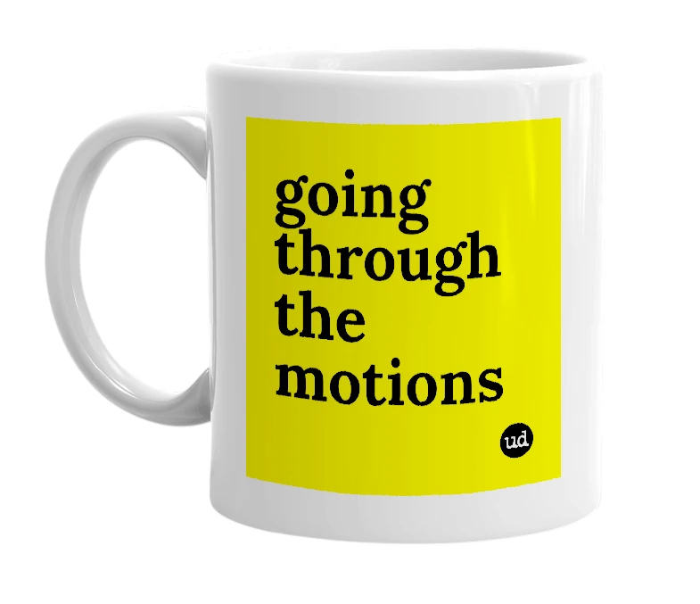 White mug with 'going through the motions' in bold black letters