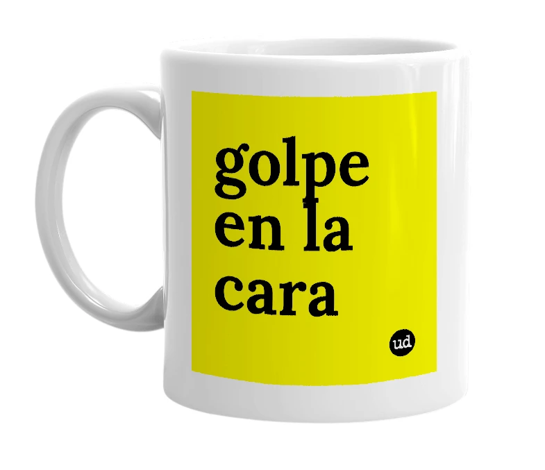 White mug with 'golpe en la cara' in bold black letters