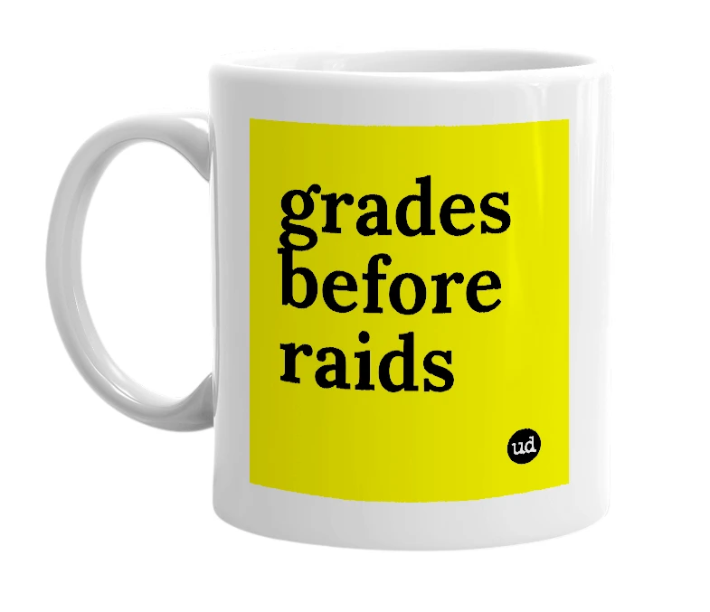 White mug with 'grades before raids' in bold black letters