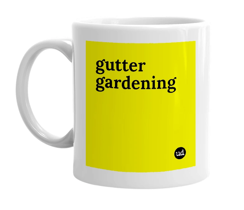 White mug with 'gutter gardening' in bold black letters