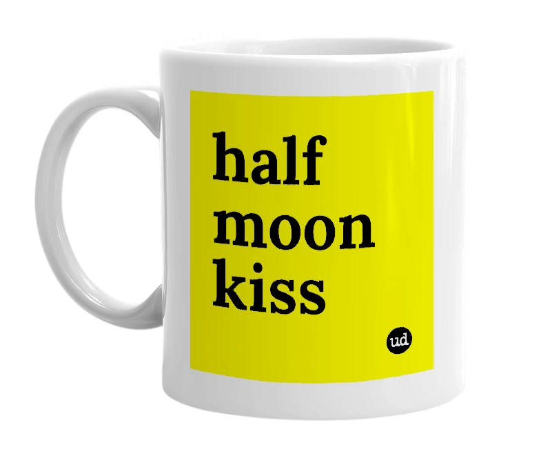 White mug with 'half moon kiss' in bold black letters