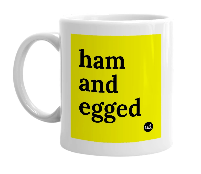 White mug with 'ham and egged' in bold black letters