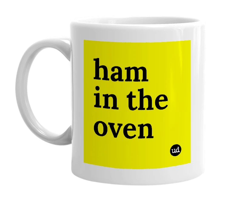 White mug with 'ham in the oven' in bold black letters