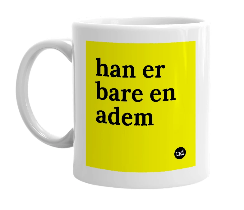 White mug with 'han er bare en adem' in bold black letters