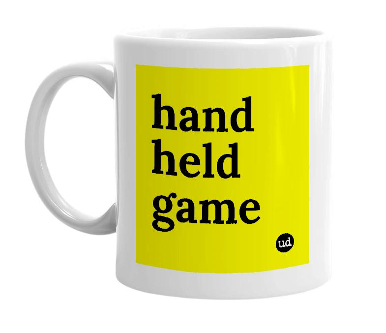 White mug with 'hand held game' in bold black letters