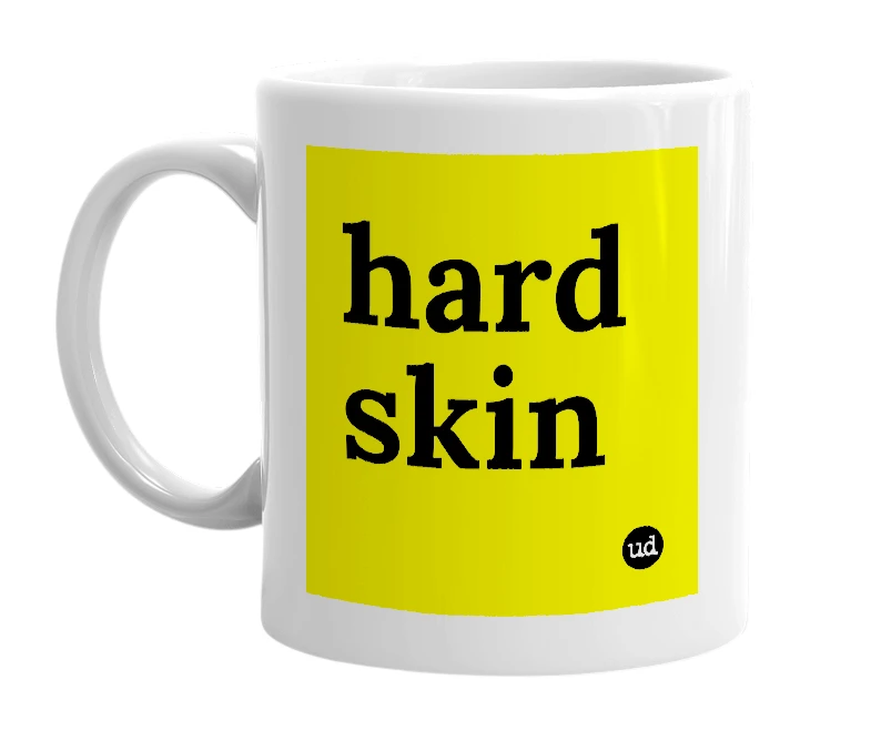 White mug with 'hard skin' in bold black letters