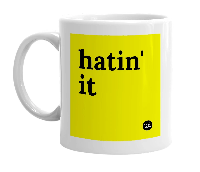 White mug with 'hatin' it' in bold black letters