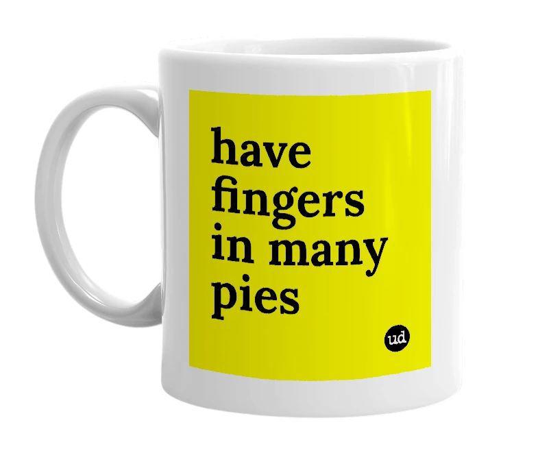 White mug with 'have fingers in many pies' in bold black letters