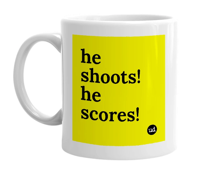 White mug with 'he shoots! he scores!' in bold black letters