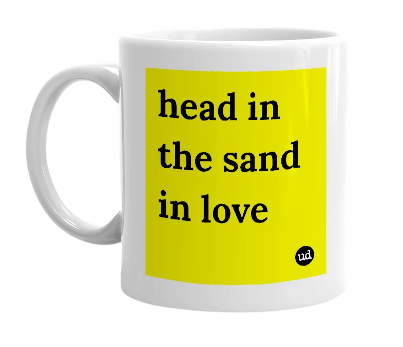White mug with 'head in the sand in love' in bold black letters