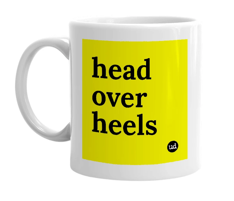 White mug with 'head over heels' in bold black letters