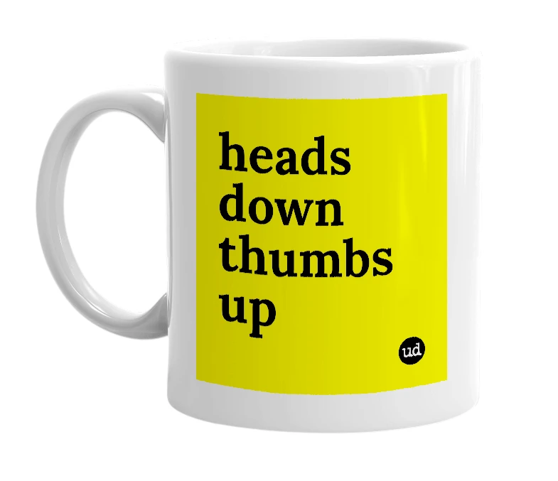 White mug with 'heads down thumbs up' in bold black letters