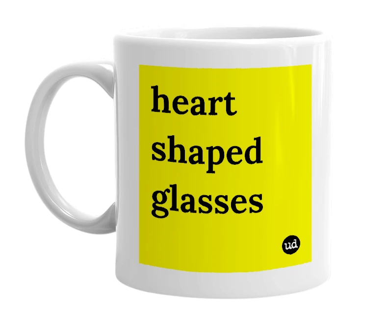 White mug with 'heart shaped glasses' in bold black letters