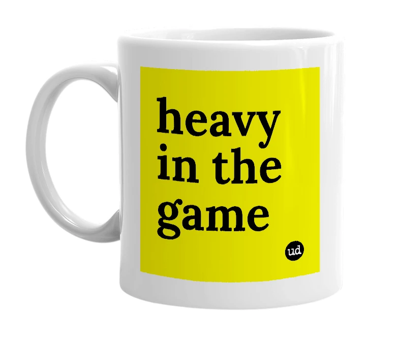 White mug with 'heavy in the game' in bold black letters