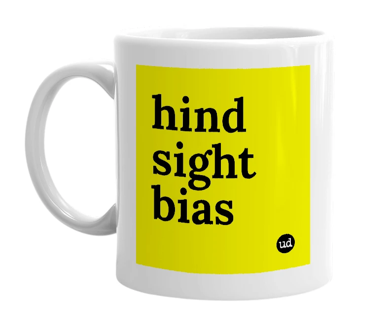 White mug with 'hind sight bias' in bold black letters