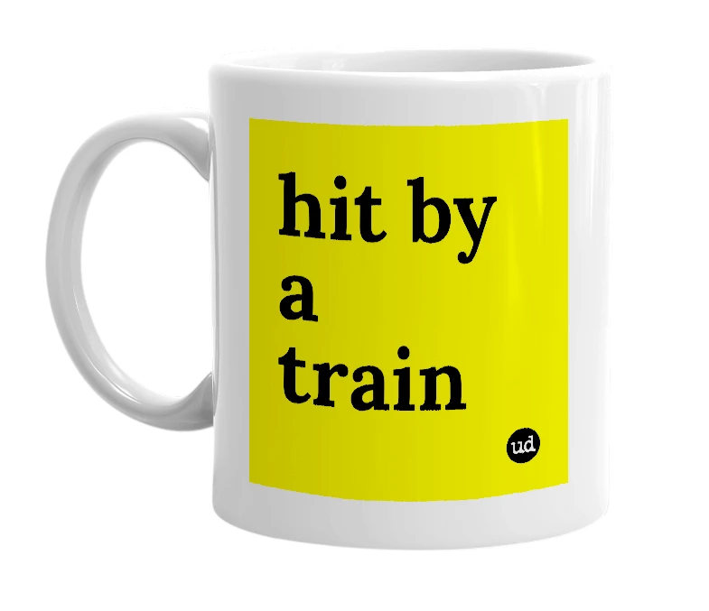 White mug with 'hit by a train' in bold black letters