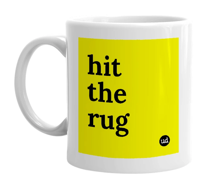 White mug with 'hit the rug' in bold black letters