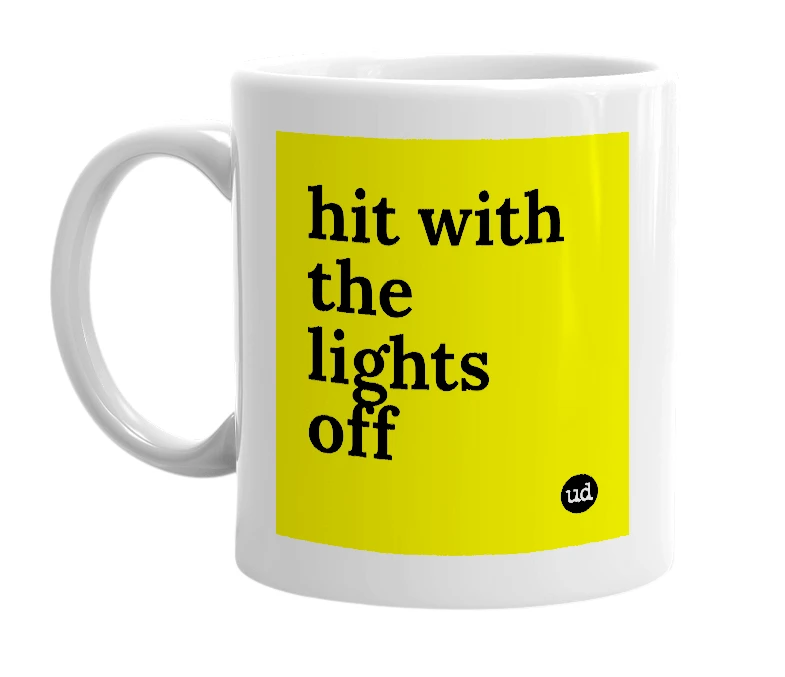 White mug with 'hit with the lights off' in bold black letters