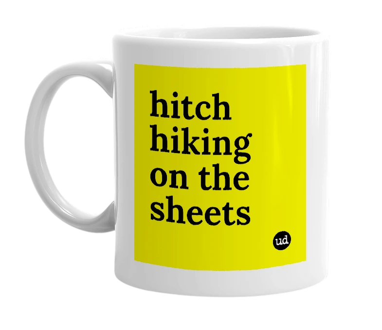 White mug with 'hitch hiking on the sheets' in bold black letters