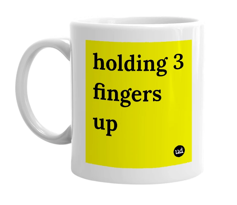 White mug with 'holding 3 fingers up' in bold black letters