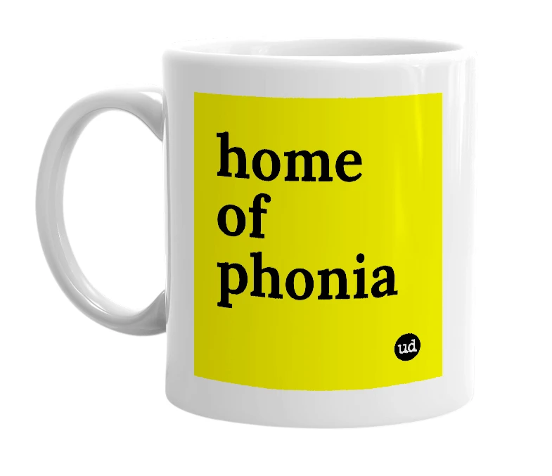 White mug with 'home of phonia' in bold black letters