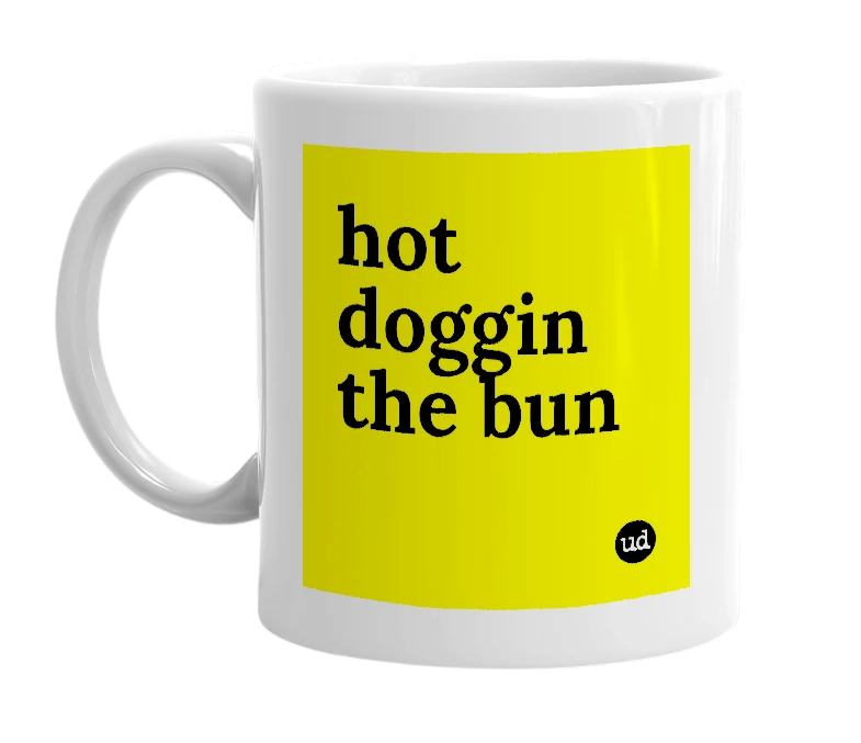 White mug with 'hot doggin the bun' in bold black letters