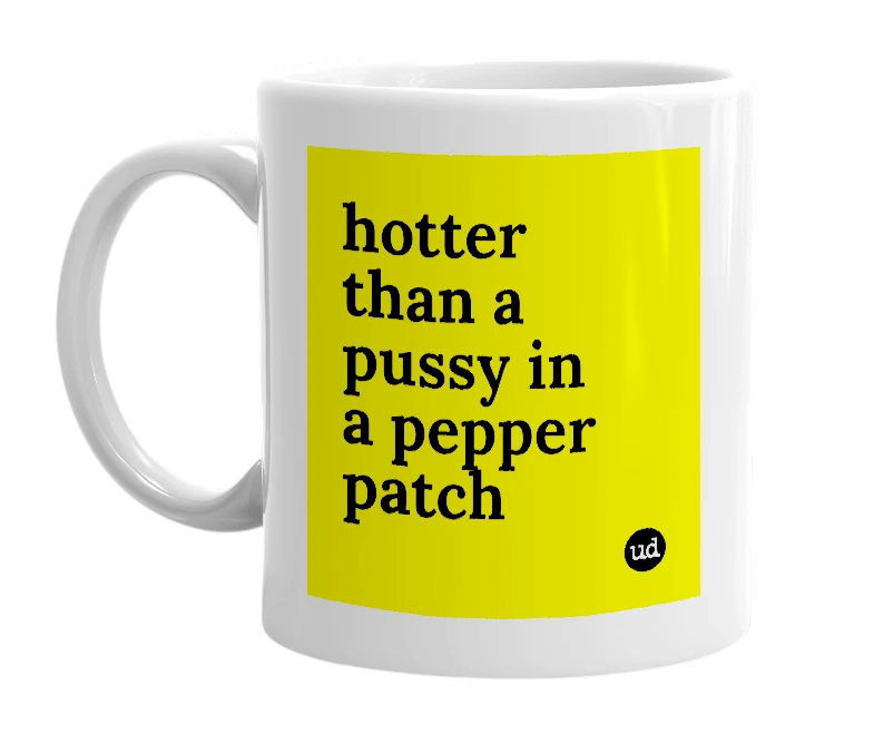 White mug with 'hotter than a pussy in a pepper patch' in bold black letters