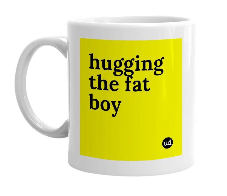 White mug with 'hugging the fat boy' in bold black letters