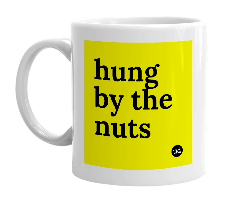 White mug with 'hung by the nuts' in bold black letters