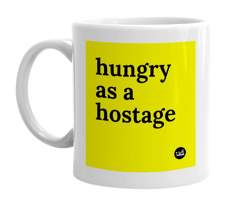 White mug with 'hungry as a hostage' in bold black letters